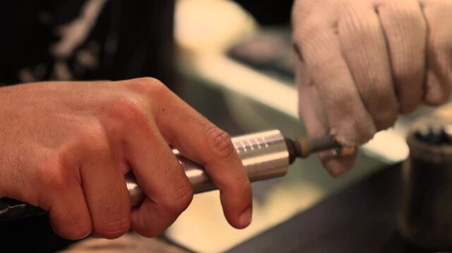 The process of making a silver finger ring by hand in an artisan workshop