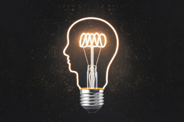 Light bulb with head shaped filament against speckled background