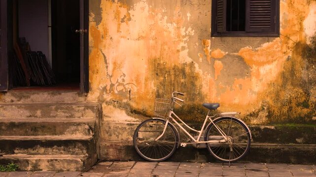 A bicycle against an old wall with an interesting texture.