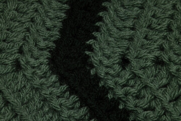 close-up of grandma's sage green and hunter green, blanket with double crochet, arrow or point, crocheted or knitted, grandma's house, turn or corner stitching from a top view