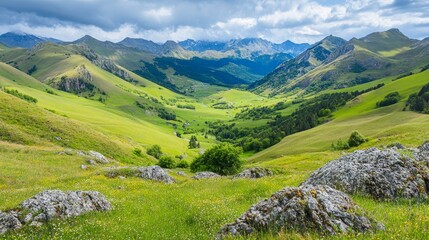 A panoramic view of a lush green valley nestled between rolling hills, with scattered rocks and a cloudy sky overhead.