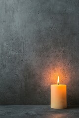 Wall with names engraved and a lone candle