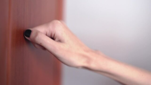 Close up of hand knocking on door. Knocking on door with fist