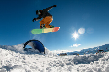 Springboard soars snowboarder. Aerial thrills and mid-air elegance.
