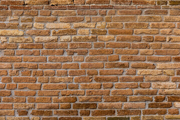 Red brick wall. Architectural seamless pattern of a rustic  wall. Textured background with copyspace.