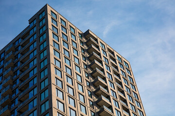 Fototapeta premium Modern Apartment Building Against Clear Blue Sky