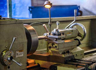 lathe machine in an workshop working tooling a metal bar