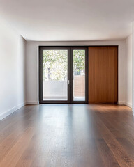 Bright interior space with large windows and wooden flooring in a modern apartment