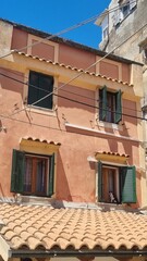 Cat on a window sill in the ancient town of Corfu