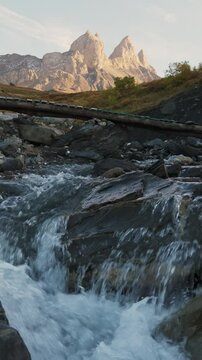 Aiguilles d Arves with iconic mountain peak and stream flowing in French Alps at France