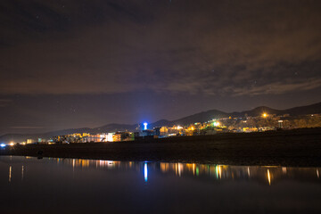 Fototapeta premium Reflection of a village on a pond at the beach at night, algeria, village, mediterranean sea, africa, north africa, algiers, aerial africa, algeria village, algerian, african village, algeria tourism.