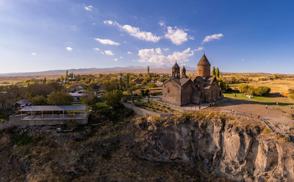 Aerial top view of Saghmosavank Monastery (13h centuries) is located huge gorge canyon of Kasakh River. Church and Mount Ara on beckground in sunny summer day. Saghmosavan, Aragatsotn, Armenia, Europe