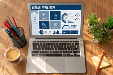 Human resources management software on computer screen helping human resources employee to manage...