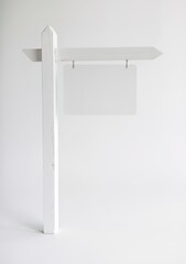 A white wooden signpost with a rectangular, blank sign hanging from it