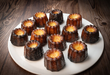 Caneles de bordeaux, traditional French sweet dessert with white table background, High quality photo