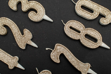 Birthday numeral candles on black background
