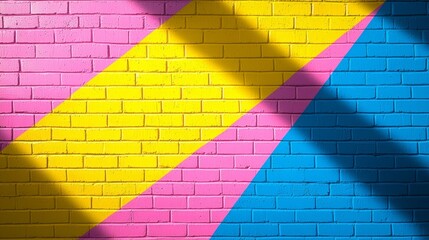 Colorful geometric mural on brick wall with bright yellow, pink, and blue patterns