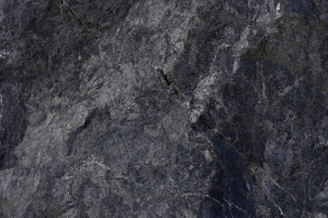 Textured gray stone with intricate patterns captured in natural light during a tranquil afternoon setting