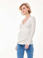 Fototapeta premium Pregnant girl model in casual clothing, photographing in the studio on a light background.