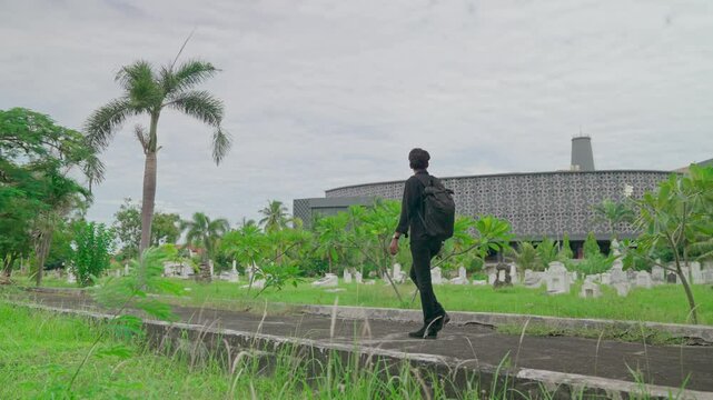 A man walks in a cemetery area of ​​Dutch soldiers in Asia