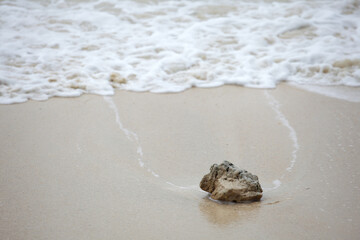 Tranquil Beach Scene with Rock and Gentle Waves