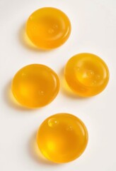 Golden amber fish oil orbs with bubbles on white background, perfect for health and wellness visuals