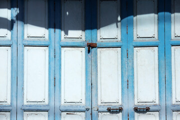 Rustic Blue Door with Shadow Play and Weathered Texture