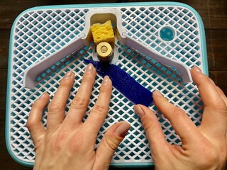 Glass grinding in workshop. Production of stained glass. Handicraft. Young woman creating. Glass...