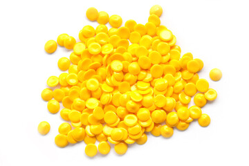 Bright Yellow Plastic Pellets on White Background