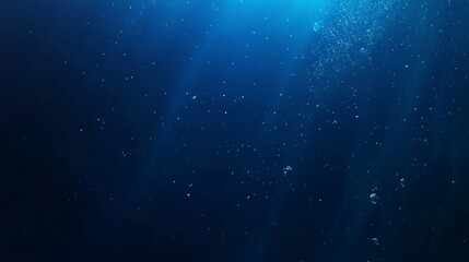 A serene underwater scene showcasing bubble and light rays in deep blue water.