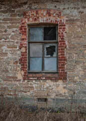 Old wooden window on the ancient abandoned house