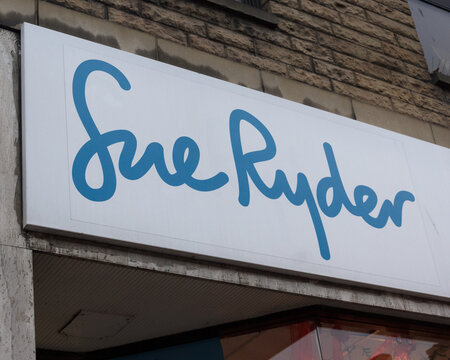 sign and logo of charity Sue Ryder who use charity shops to fund their palliative care and bereavement support  counselling and end of life work in hospices