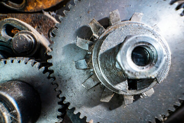 A close-up of industrial metal gears showcases precision engineering and mechanical design. The intricate machinery parts highlight the complexity of industrial manufacturing processes and technology.