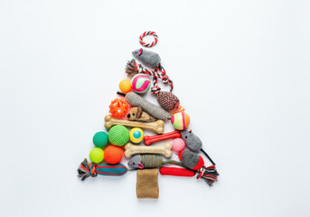 Fototapeta premium Christmas tree made of toys for cats and dogs: ropes, mice, bones and balls, on a white background. Top view