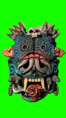 painted tiki mask with green background