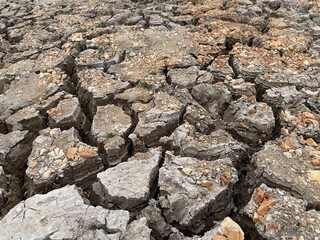 Dry land that has cracks, dry soil texture, barren land. Dry land caused by global warming or climate change and water shortages.