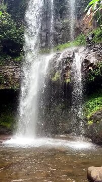 Vertical video. Lower part of waterfall in Khy du lich Thac Dambri area. Slow motion. Damb'ri resort. Bao Loc plateau center. Vietnam.
