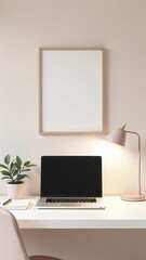 Fototapeta premium A laptop sits on a desk next to a potted plant and a framed picture