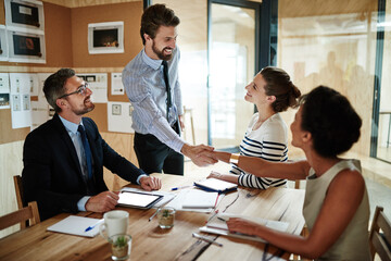 Planning, meeting and business people with handshake, partnership and project brainstorming for ideas. Agency, diversity and team director for creative, b2b deal and workshop collaboration in office