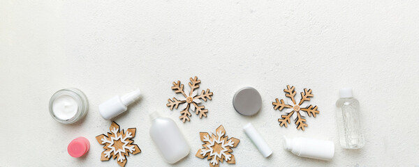 Makeup products and Christmas decorations on color background. Top view New year Beauty concept with copy space