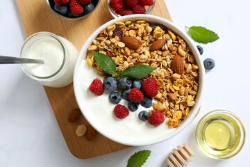 Delicious granola with berries and yogurt on the table
