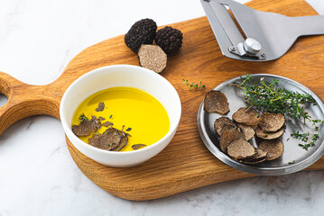 Olive oil with black truffles. How to preserve the aroma of truffles. Fragrant autumn oil, gourmet supplement. Autumn gourmet cuisine of Piedmont, Northern Italy