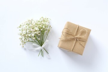 Top view photo with gift box and gypsophila flowers on white background