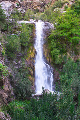 Waterfall falling from the rocks and trees around it in middle of forest and mountain in Jijel, Algeria, Africa, Beautiful waterfall for landscape, River waterfall, rain water and stream, water fall.