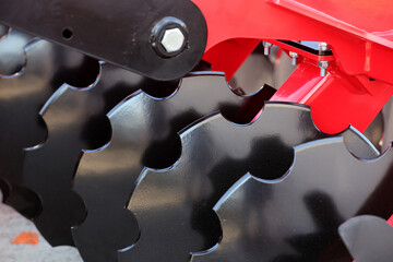 A plow for tilling the soil is displayed at an agricultural equipment fair