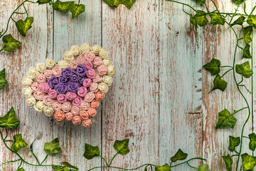 Heart bouquet of flowers on the table. Floral heart background to celebrate special occasions.