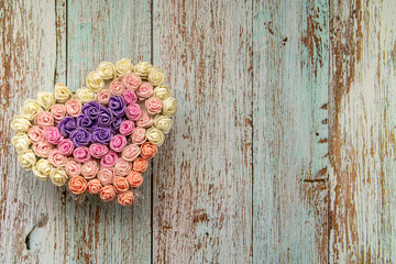 Heart bouquet of flowers on the table. Floral heart background to celebrate special occasions.