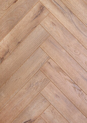 the texture of the wooden floor covering in a herringbone pattern. close-up photo of the surface