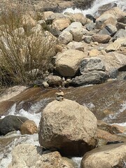 Stacked rocks at a waterfall in the mountains 