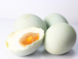 close up slice of salted eggs isolated on a white background, traditional salted duck eggs from brebes, central java, indonesia,